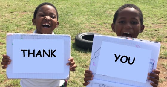 two children holding the words thank you