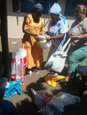 women sharing out rice and provisions