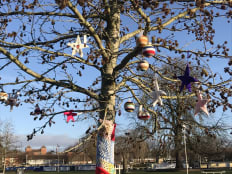 Yarnbombed tree Stratford upon Avon with baubles & stars